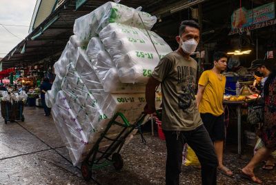 A worker at a market in Bangkok in June 2026.