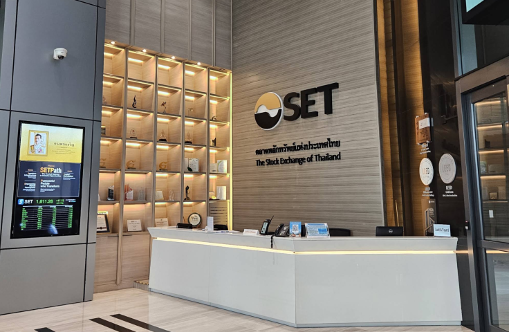 Interior of the Stock Exchange of Thailand featuring a reception area and digital display